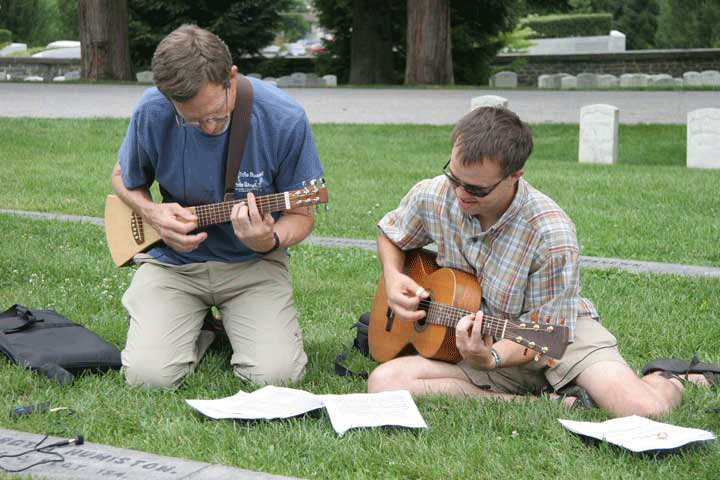 2006 "Voices Across Time" participants Robert Tam and Mark Dillon play at the grave of a Civil War soldier in Gettysburg.